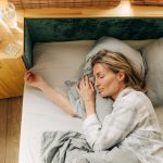 Homeowner sleeping soundly in a quiet, cool room after successful air conditioning repairs.